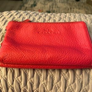 This is a pink Coach New York wallet.